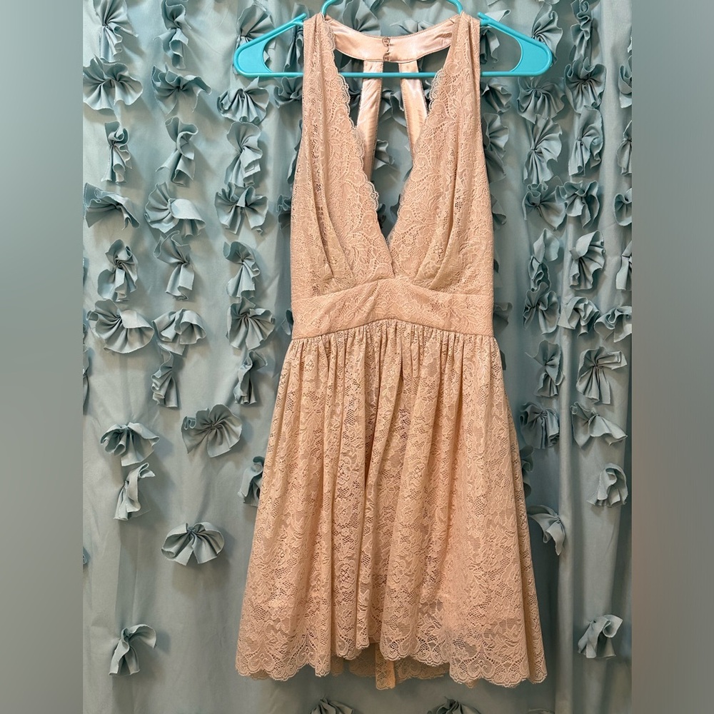 Beautiful mini with low cut. Never been worn. Still has tags